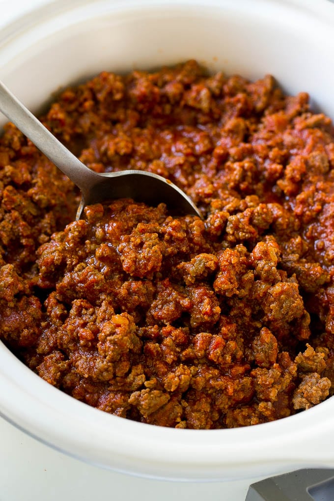 Slow cooker sloppy joe meat with a serving spoon.