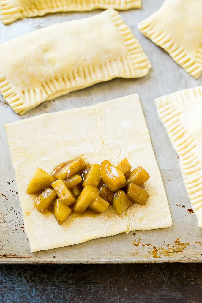 Fried Apple Pies Recipe | McDonald's Copycat Recipe | Apple Pie | Apple Hand Pies #pie #apples #applepie #dessert #snack #edsug A sheet of puff pastry topped with homemade apple pie filling.
