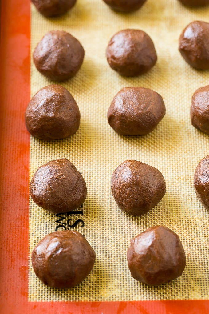 Nutella Cookies Recipe | Nutella Stuffed Cookies | Chocolate Cookies #nutella #chocolate #cookies #baking #dessert #edsug Balls of chocolate cookie dough on a baking sheet.