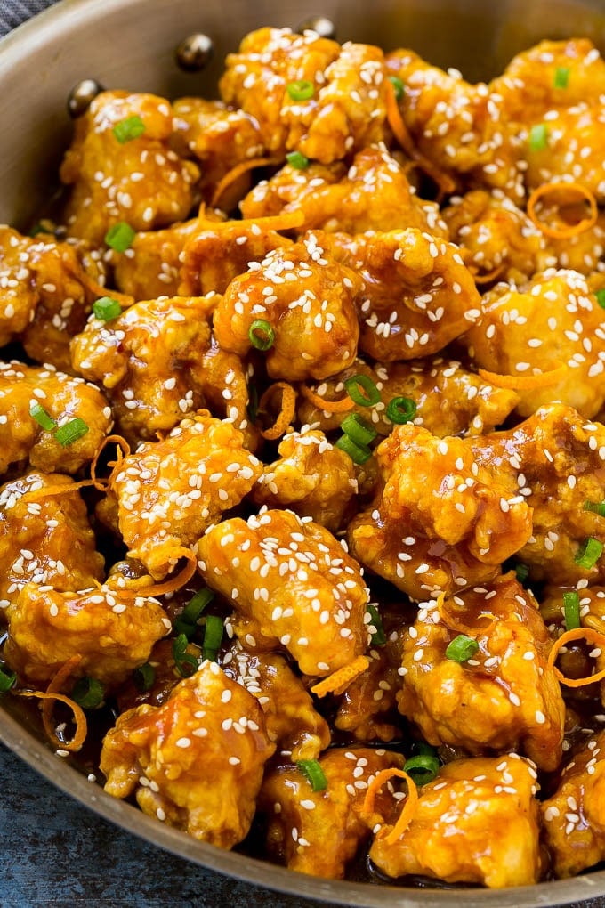 Orange Chicken Recipe | Chinese Orange Chicken | Panda Express Orange Chicken #orange #chicken #takeout #chinesefood #dinner #edsug Orange chicken in a skillet with crispy chicken, sesame seeds, orange zest and green onions.
