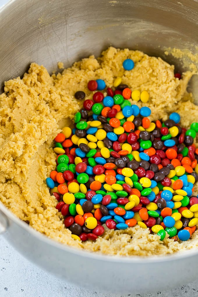 Oreo Stuffed Cookies Recipe | M&M's cookies | Stuffed Cookies #cookies #chocolate #oreos #dessert #baking #edsug Cookie dough in a mixing bowl with miniature M&M's in it.