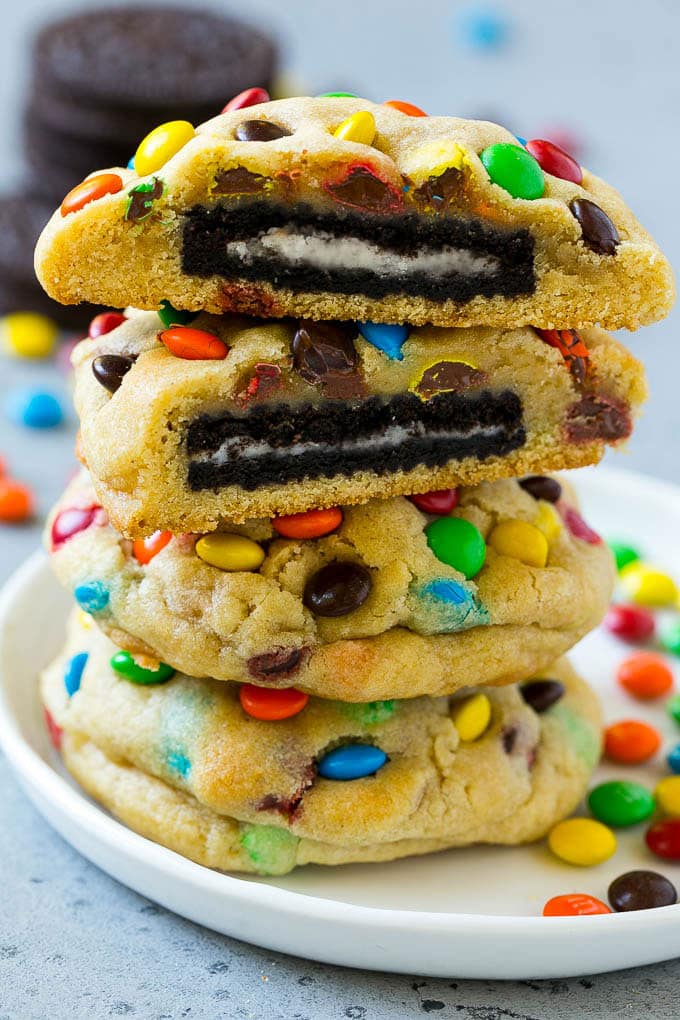 Oreo Stuffed Cookies Recipe | M&M's cookies | Stuffed Cookies #cookies #chocolate #oreos #dessert #baking #edsug A stack of Oreo stuffed cookies on a plate.