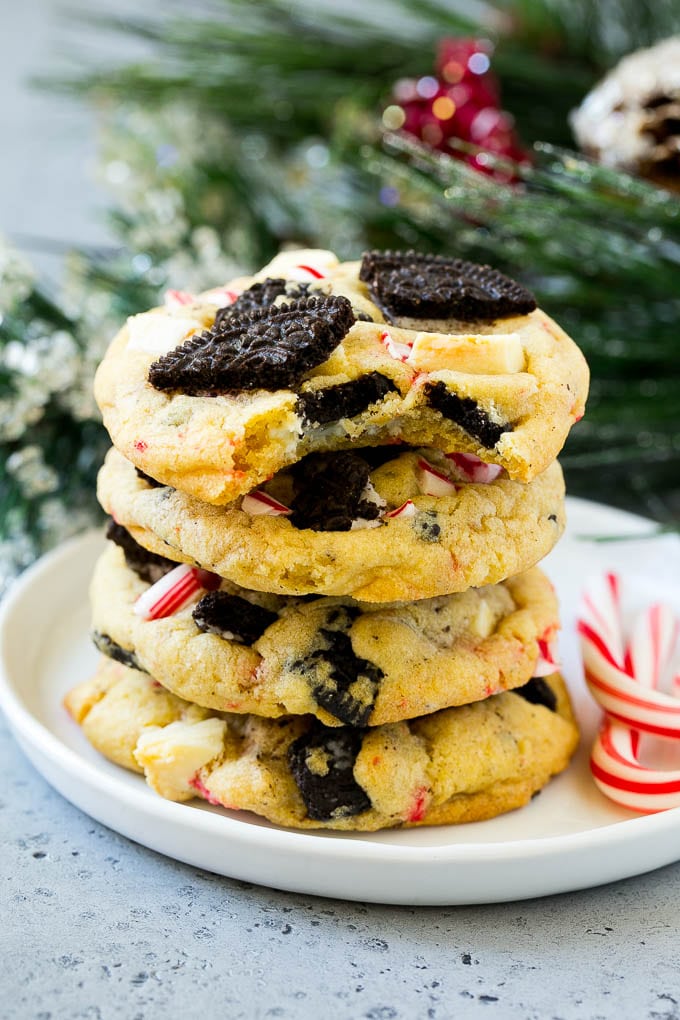 Oreo Peppermint Cookies Recipe | Candy Cane Cookies | Oreo Cookies #oreo #peppermint #cookies #baking #Christmas #sweets #edsug A stack of Oreo peppermint cookies on a plate, garnished with candy canes.
