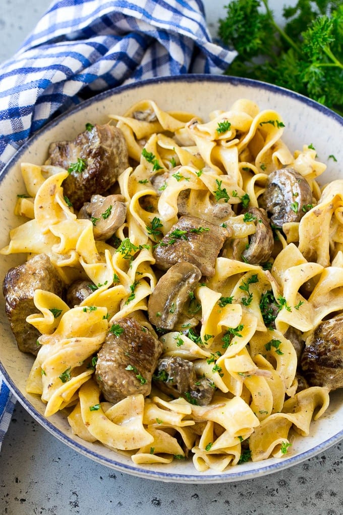 Slow Cooker Beef Stroganoff Recipe | Crock Pot Beef Stroganoff | Beef Recipe #slowcooker #crockpot #beef #mushrooms #pasta #dinner #edsug A bowl of slow cooker beef stroganoff with egg noodles.