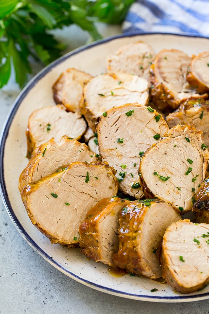 Slow Cooker Pork Tenderloin Recipe | Crock Pot Pork Tenderloin | Easy Pork Tenderloin #slowcooker #crockpot #pork #dinner #edsug Sliced slow cooker pork tenderloin on a plate.