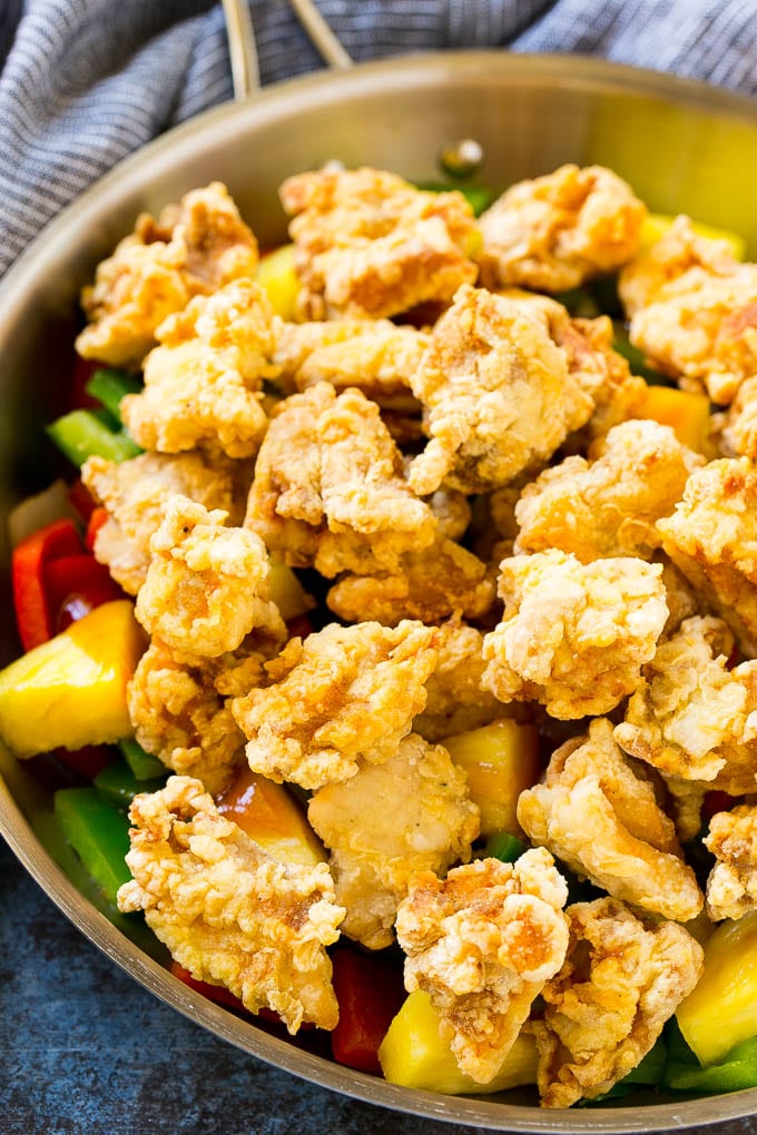 Sweet and Sour Chicken Recipe | Chinese Food Copycat Recipe | Chicken with Pineapple #chicken #chinesefood #pineapple #stirfry #takeout #dinner #edsug Fried chicken pieces in a pan with pineapple, peppers and onions.