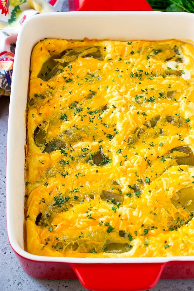 Chile Relleno Casserole Recipe | Baked Chile Rellenos | Mexican Casserole #casserole #chiles #mexican #cheese #dinner #edsug A dish of chile relleno casserole topped with cheddar cheese and chopped cilantro.