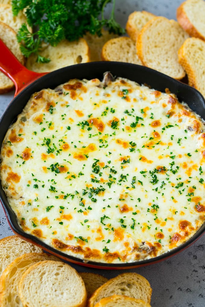 Philly Cheesesteak Dip Recipe | Cheesy Dip | Baked Cheese Dip #steak #dip #appetizer #cheese #edsug A skillet of baked Philly cheesesteak dip with melted cheese and parsley on top.