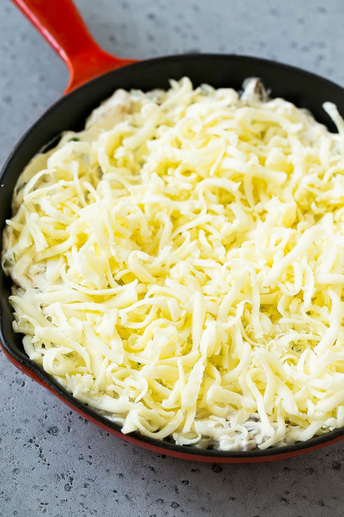 Philly Cheesesteak Dip Recipe | Cheesy Dip | Baked Cheese Dip #steak #dip #appetizer #cheese #edsug Philly cheesesteak dip with shredded cheese on top, waiting to go into the oven.