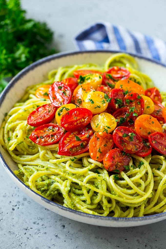 Pesto pasta topped with roasted cherry tomatoes.