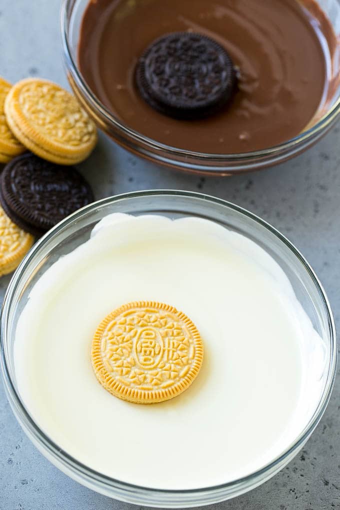 Chocolate Covered Oreos Recipe | Oreo Cookies | Chocolate Dipped Oreos #oreo #cookies #chocolate #sprinkles #dessert #edsug Cookies being dipped into dark and white chocolate.