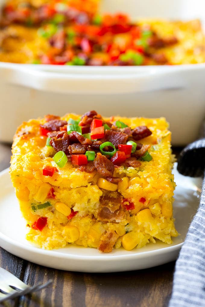 Loaded Corn Casserole Recipe | Easy Corn Casserole | Bacon Corn Casserole | Corn Pudding #corn #casserole #bacon #cheese #sidedish #thanksgiving #dinner #edsug A serving of corn casserole filled with bacon, cheese and peppers.