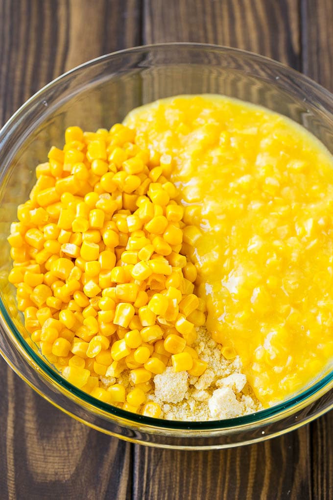 Loaded Corn Casserole Recipe | Easy Corn Casserole | Bacon Corn Casserole | Corn Pudding #corn #casserole #bacon #cheese #sidedish #thanksgiving #dinner #edsug Cornbread mix, corn and creamed corn in a mixing bowl.