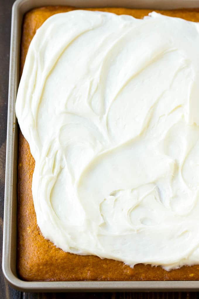 Pumpkin Bars Recipe | Pumpkin Cake | Pumpkin Dessert #pumpkin #fall #dessert #edsug #thanksgiving Cream cheese frosting spread over cake.