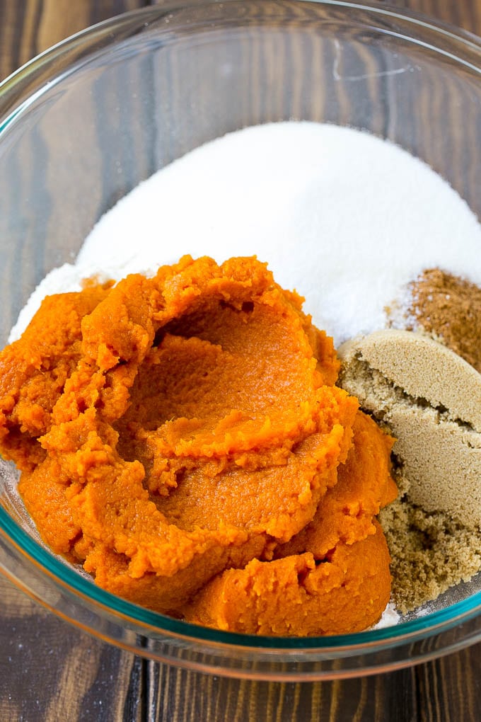Pumpkin Bars Recipe | Pumpkin Cake | Pumpkin Dessert #pumpkin #fall #dessert #edsug #thanksgiving Pumpkin puree, brown sugar and flour in a bowl.