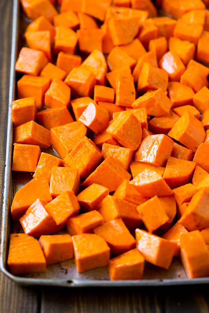 Maple Roasted Sweet Potatoes Recipe | Easy Sweet Potatoes | Baked Sweet Potatoes | Sweet Potato Side Dish #sweetpotatoes #cinnamon #maple #butter #fall #sidedish #dinner #edsug Raw diced sweet potatoes on a sheet pan, ready to go into the oven.