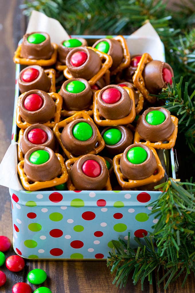 Rolo Pretzels Recipe | Chocolate Pretzels | Caramel Pretzels | Holiday Candy #christmas #baking #dessert #candy #chocolate #caramel #pretzels #edsug A gift tin full of Christmas colored Rolo pretzels.