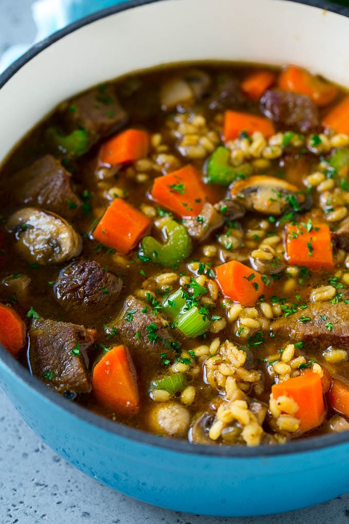 Beef Barley Soup Recipe | Beef Soup | Barley Soup #soup #beef #dinner #vegetables #edsug #comfortfood A pot of beef barley soup with mushrooms, carrots and celery.