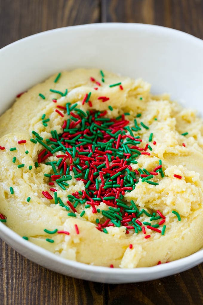Cake Mix Cookies Recipe | Sprinkle Cookies | Christmas Cookies #cookies #christmas #sprinkles #dessert #baking #edsug A bowl of dough with sprinkles on top.