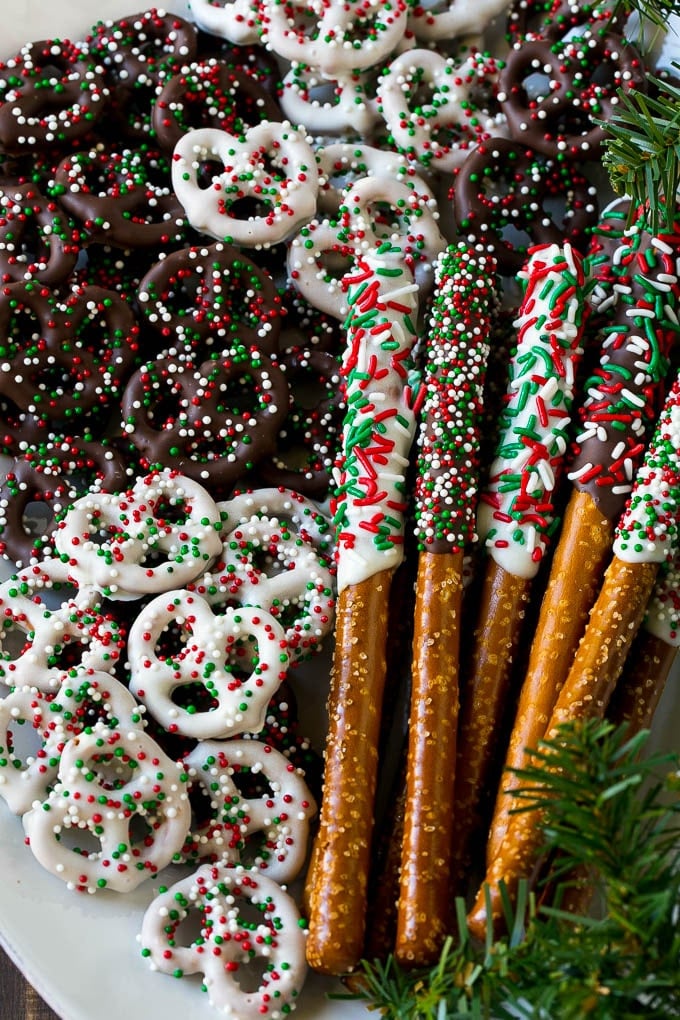 Chocolate Covered Pretzels Recipe | Sprinkle Pretzels | No Bake Dessert #pretzels #chocolate #christmas #sprinkles #candy #edsug Chocolate covered pretzel twists and rods on a serving platter.