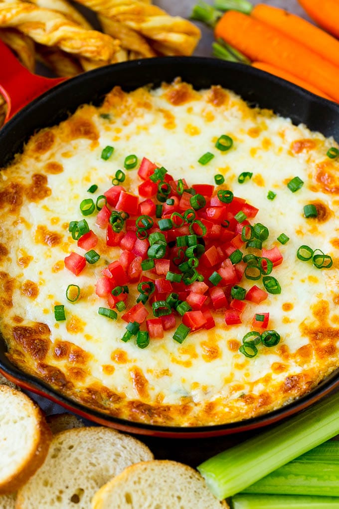 Crab Dip Recipe | Hot Crab Dip | Seafood Dip #dip #crab #seafood #appetizer #edsug #cheese Hot crab dip in a skillet topped with tomatoes and green onions.