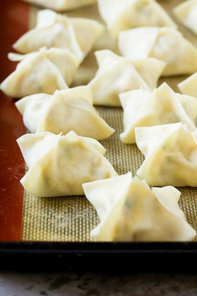Crab Rangoon Recipe | Crab Wontons | Cream Cheese Wontons #crab #cheese #appetizer #snack #chinesefood #dinner #edsug Raw wontons ready to go into the fryer.