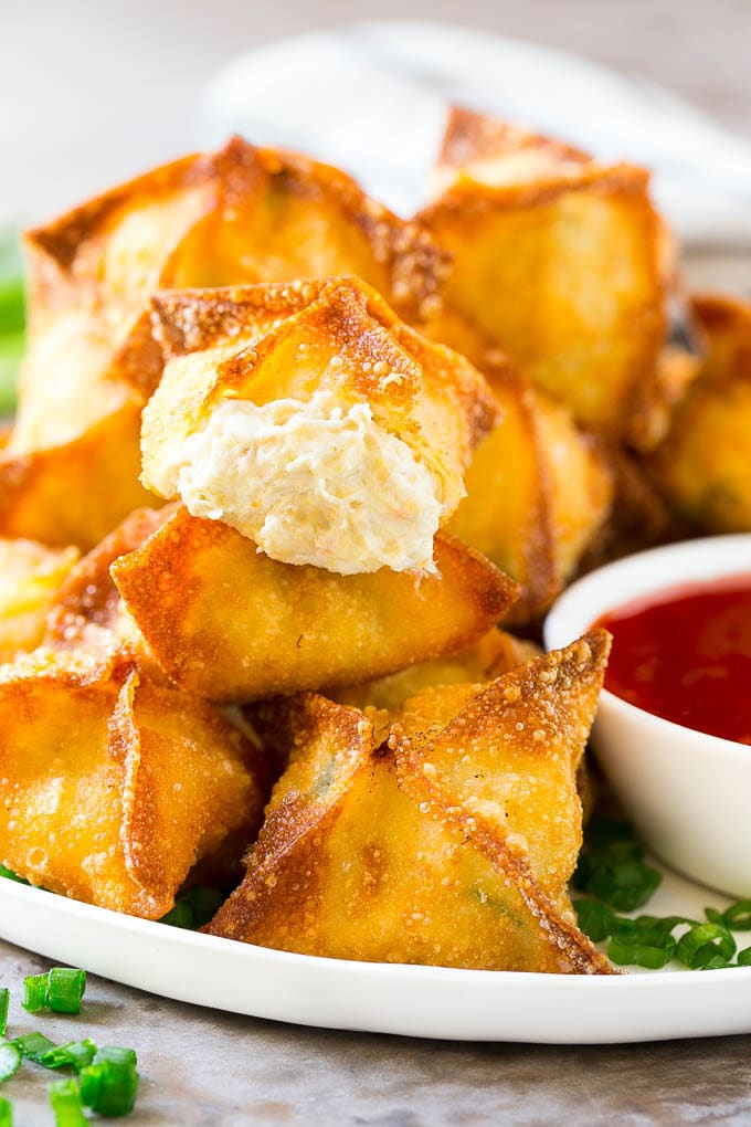 Crab Rangoon Recipe | Crab Wontons | Cream Cheese Wontons #crab #cheese #appetizer #snack #chinesefood #dinner #edsug A cross section of crab rangoon with crispy wontons stuffed with cream cheese and crab.