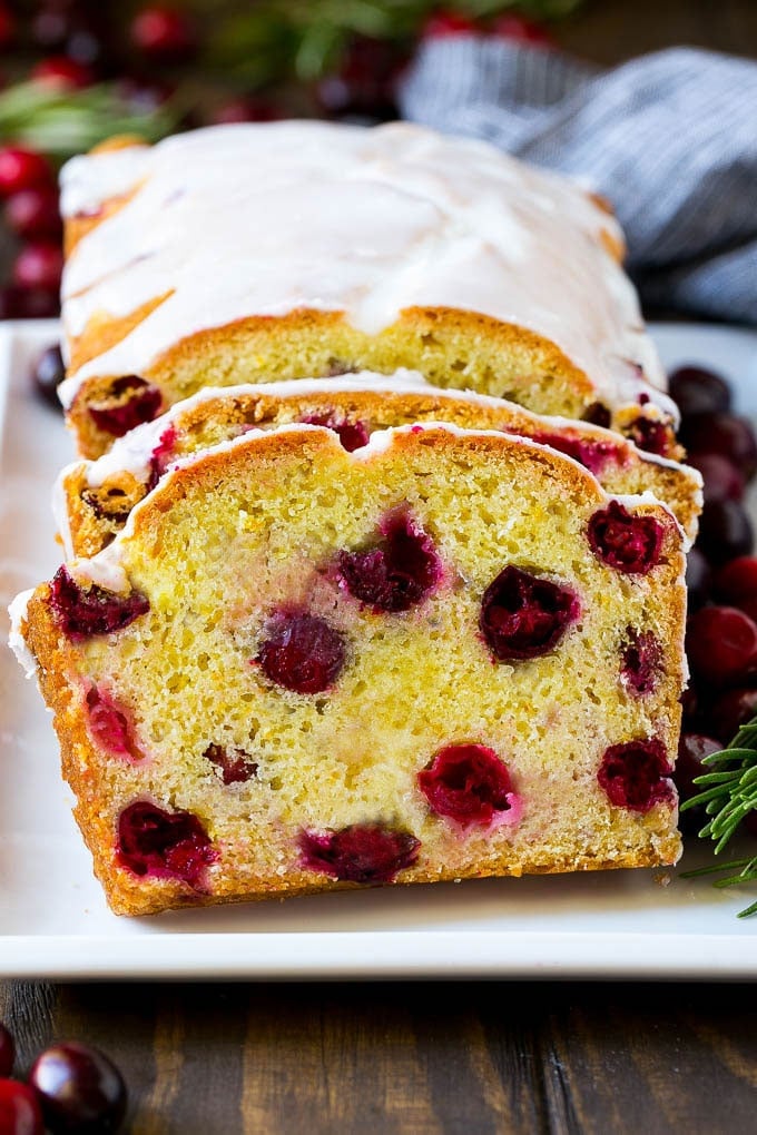 Cranberry Bread Recipe | Cranberry Loaf | Cranberry Orange Bread #cranberry #bread #baking #dessert #fall #edsug Sliced cranberry bread on a serving plate.
