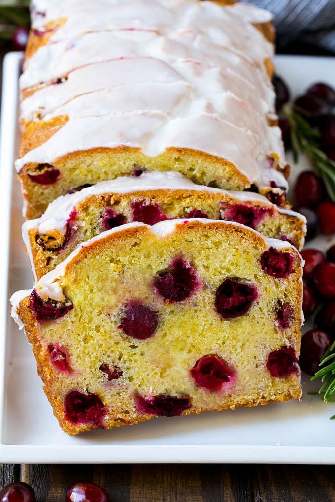 Cranberry Bread Recipe | Cranberry Loaf | Cranberry Orange Bread #cranberry #bread #baking #dessert #fall #edsug Slices of cranberry bread topped with orange glaze.