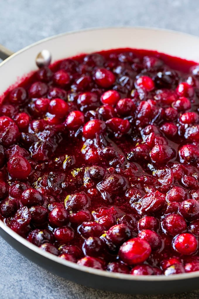 Cranberry Orange Sauce Recipe | Homemade Cranberry Sauce | Fresh Cranberry Sauce #cranberry #orange #fall #thanksgiving #sauce #dinner #edsug Cranberry orange sauce simmering in a skillet.