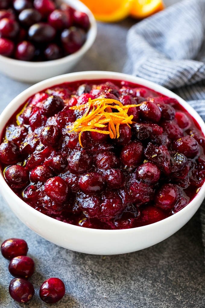 Cranberry Orange Sauce Recipe | Homemade Cranberry Sauce | Fresh Cranberry Sauce #cranberry #orange #fall #thanksgiving #sauce #dinner #edsug A bowl of cranberry orange sauce topped with fresh orange zest.