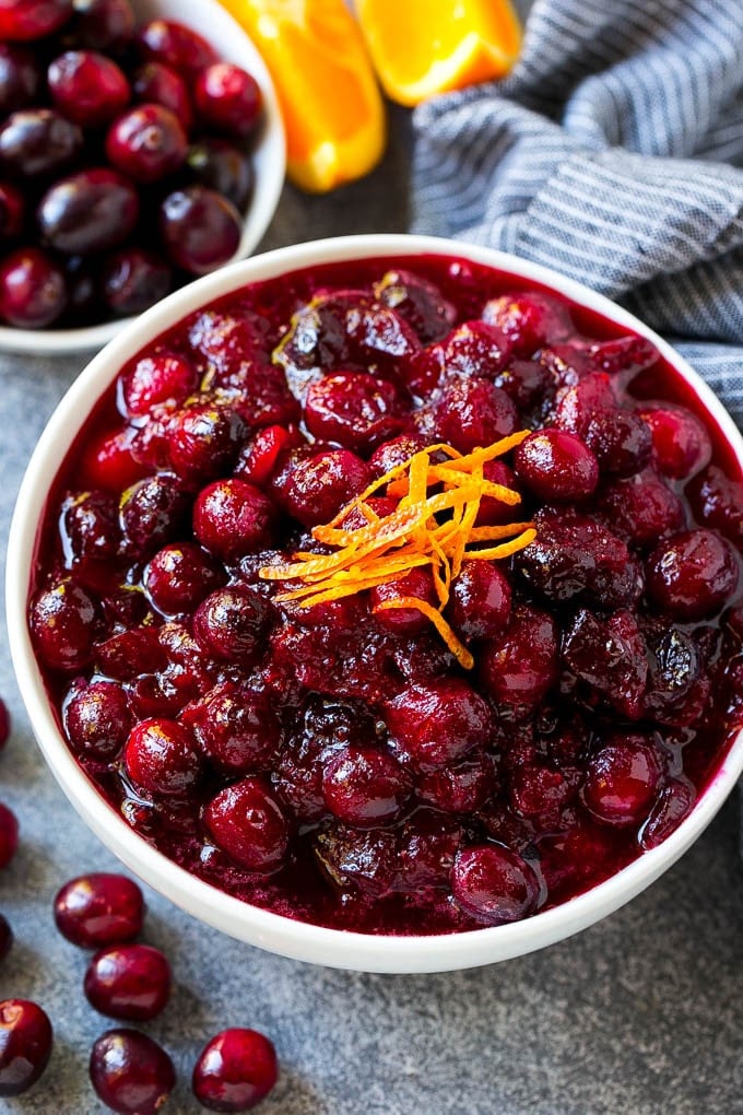 Cranberry Orange Sauce Recipe | Homemade Cranberry Sauce | Fresh Cranberry Sauce #cranberry #orange #fall #thanksgiving #sauce #dinner #edsug Cranberry orange sauce, topped with fresh orange zest in a serving bowl.
