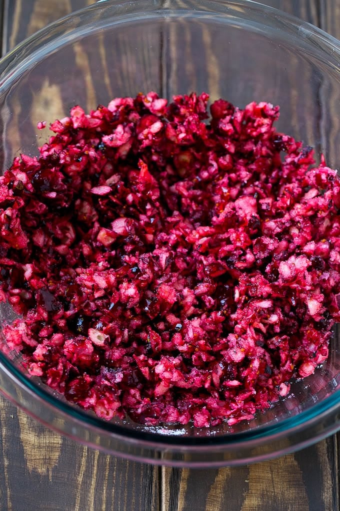 Cranberry Salad Recipe | Fluff Salad #cranberry #salad #fall #dinner #edsug #thanksgiving Chopped cranberries mixed with sugar in a bowl.