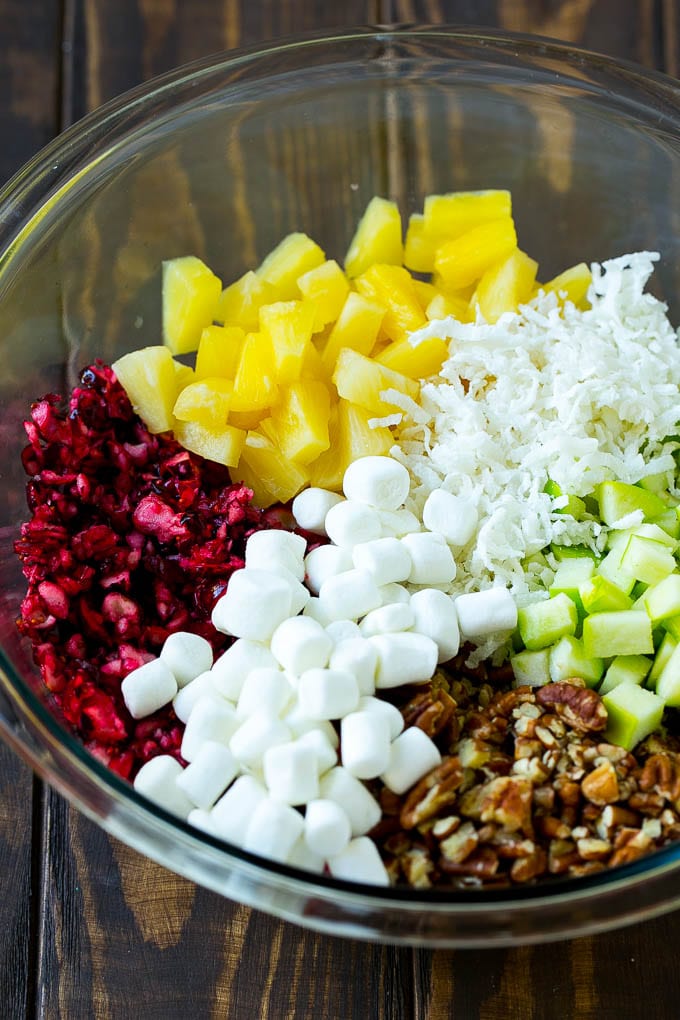 Cranberry Salad Recipe | Fluff Salad #cranberry #salad #fall #dinner #edsug #thanksgiving Chopped cranberries, apples, pineapple, marshmallows, pecans and coconut in a mixing bowl.