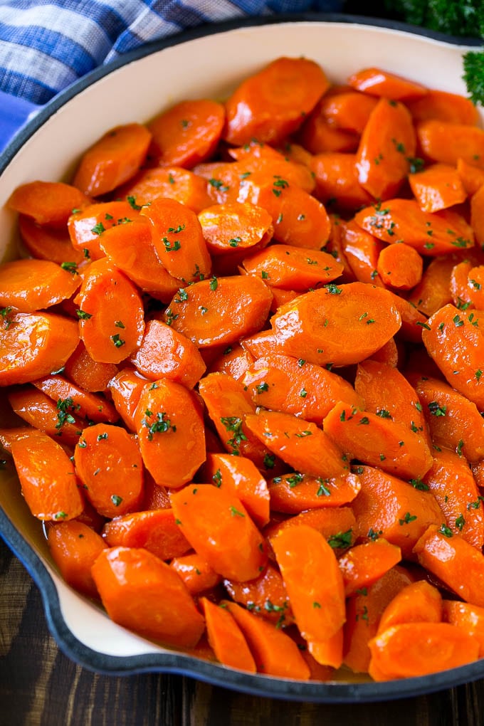 Glazed Carrots Recipe | Brown Sugar Carrots | Carrot Side Dish #carrots #brownsugar #sidedish #glutenfree #thanksgiving #fall #dinner #edsug A skillet of glazed carrots with brown sugar and butter sauce.