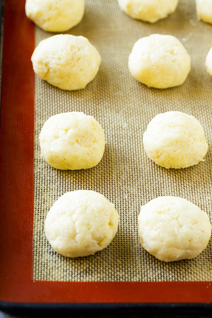 Gooey Butter Cookies Recipe | Cake Mix Cookies | Sprinkle Cookies | Christmas Cookies #cookies #butter #sprinkles #christmas #dessert #baking #edsug Balls of dough on a baking sheet.
