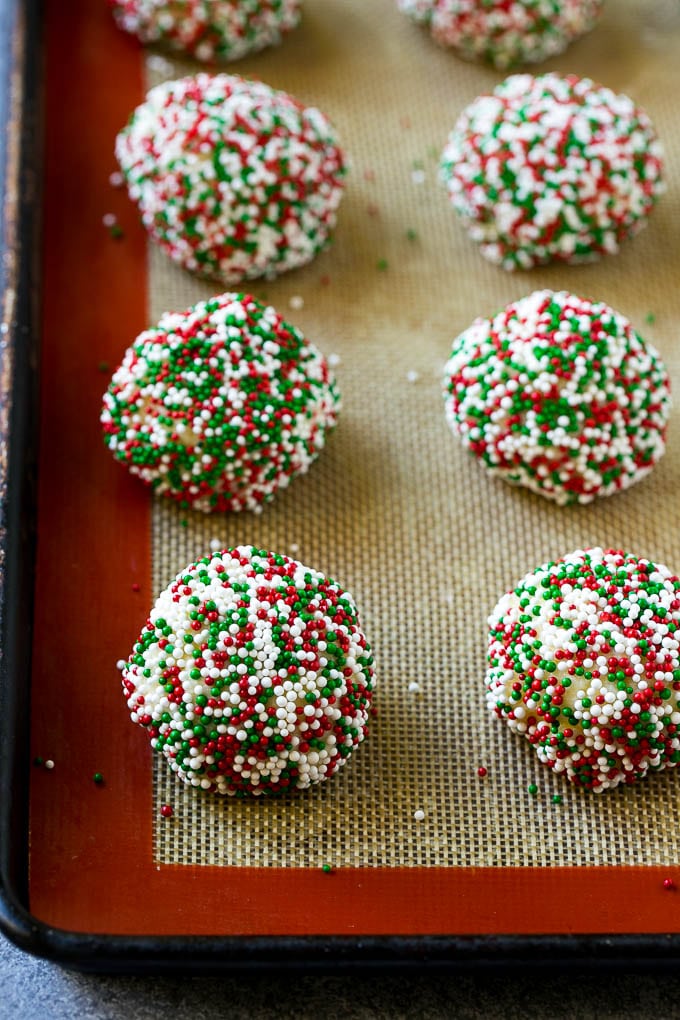 Gooey Butter Cookies Recipe | Cake Mix Cookies | Sprinkle Cookies | Christmas Cookies #cookies #butter #sprinkles #christmas #dessert #baking #edsug Balls of dough rolled in sprinkles.