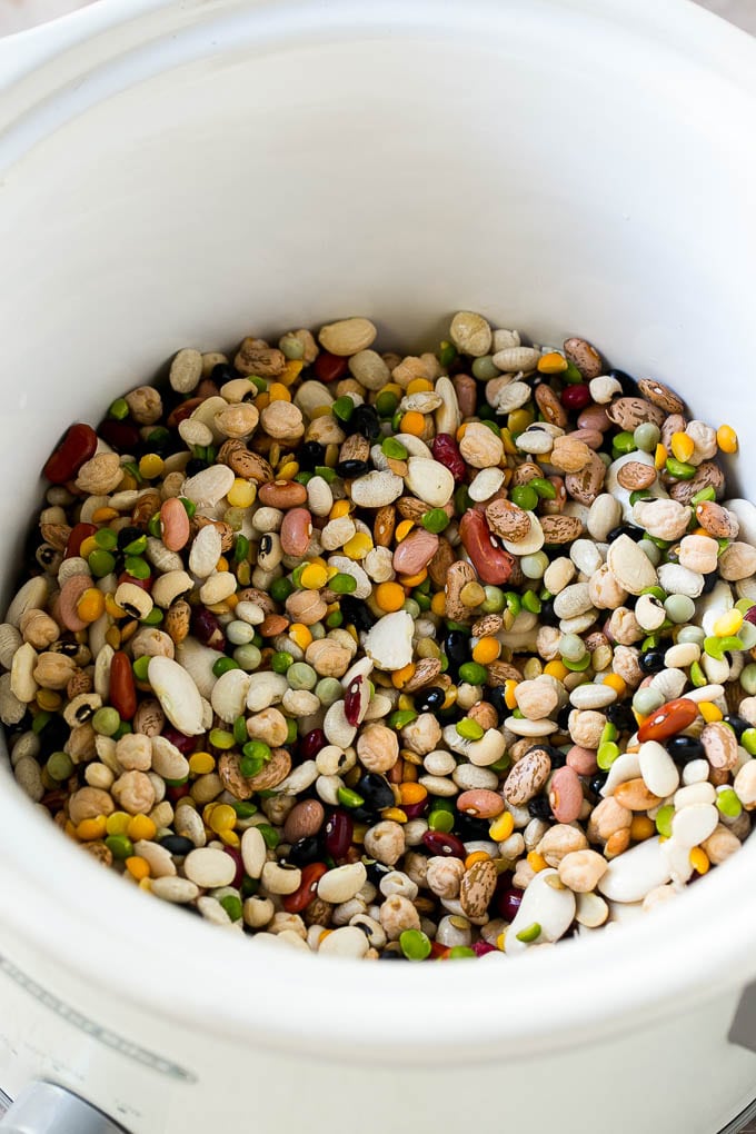 Ham and Bean Soup Recipe | Slow Cooker Ham and Bean Soup | Crockpot Ham and Bean Soup | Leftover Ham Recipe #ham #beans #soup #slowcooker #crockpot #dinner #edsug A mixture of dried beans in a crock pot.