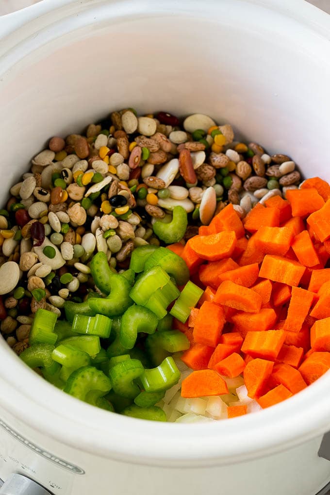 Ham and Bean Soup Recipe | Slow Cooker Ham and Bean Soup | Crockpot Ham and Bean Soup | Leftover Ham Recipe #ham #beans #soup #slowcooker #crockpot #dinner #edsug Dried beans, carrots, onions and celery in the slow cooker.