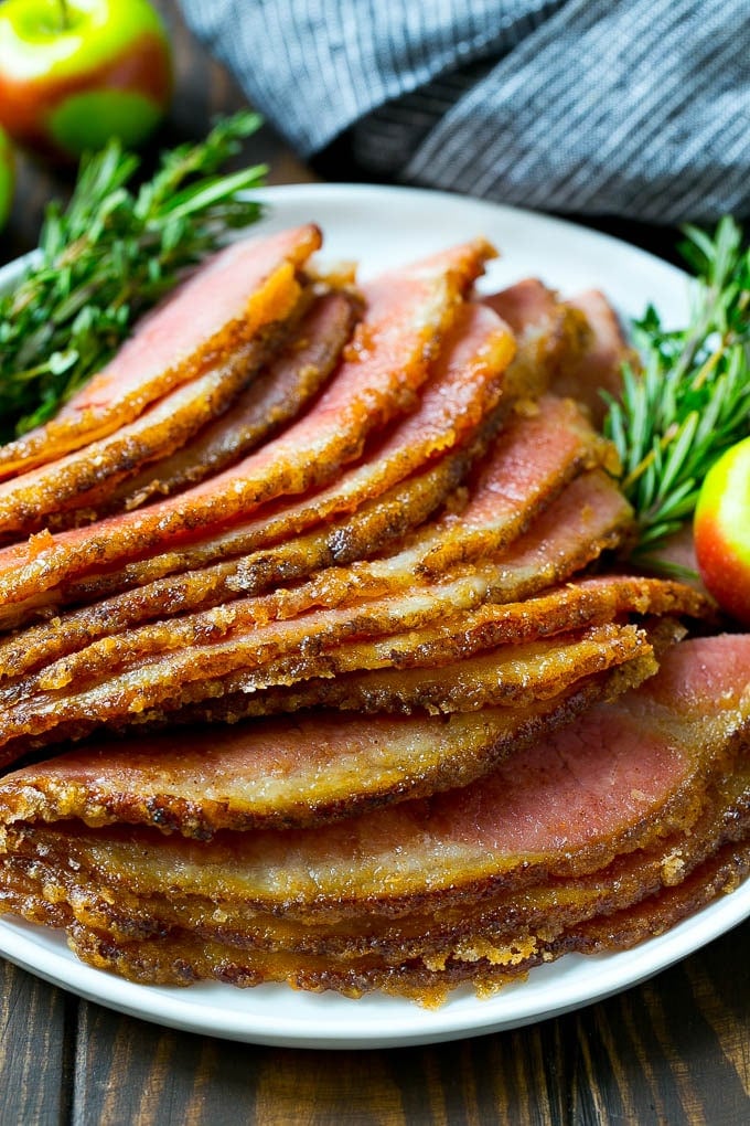 Honey Baked Ham Recipe | Glazed Ham | Holiday Ham #ham #dinner #edsug #christmas #thanksgiving #easter Sliced honey baked ham on a serving plate.