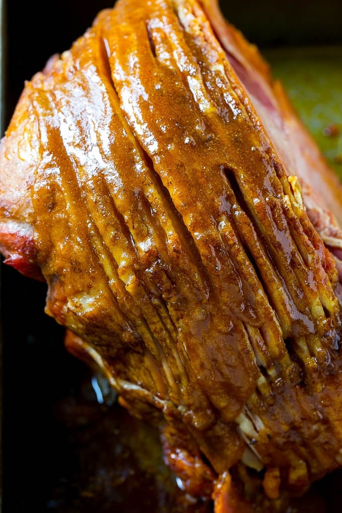 Honey Baked Ham Recipe | Glazed Ham | Holiday Ham #ham #dinner #edsug #christmas #thanksgiving #easter A ham coated in sugar glaze in a baking pan.
