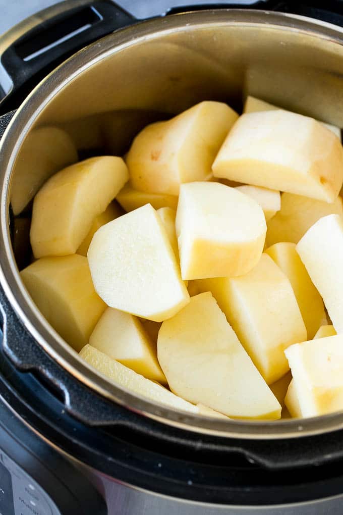 Instant Pot Mashed Potatoes Recipe | Pressure Cooker Mashed Potatoes | Easy Mashed Potatoes #potatoes #sidedish #instantpot #thanksgiving #dinner #edsug Peeled potatoes in an Instant Pot.