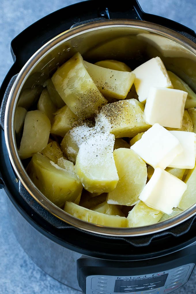 Instant Pot Mashed Potatoes Recipe | Pressure Cooker Mashed Potatoes | Easy Mashed Potatoes #potatoes #sidedish #instantpot #thanksgiving #dinner #edsug Cooked chunks of potatoes with butter, milk and seasonings in an Instant Pot.