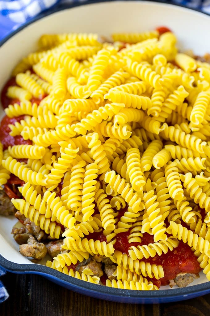 Pizza Pasta Recipe | Pepperoni Pasta | Sausage Pasta #italian #pepperoni #sausage #pizza #pasta #dinner #edsug #onepot Pepperoni, sausage, tomato sauce and uncooked pasta in a skillet.