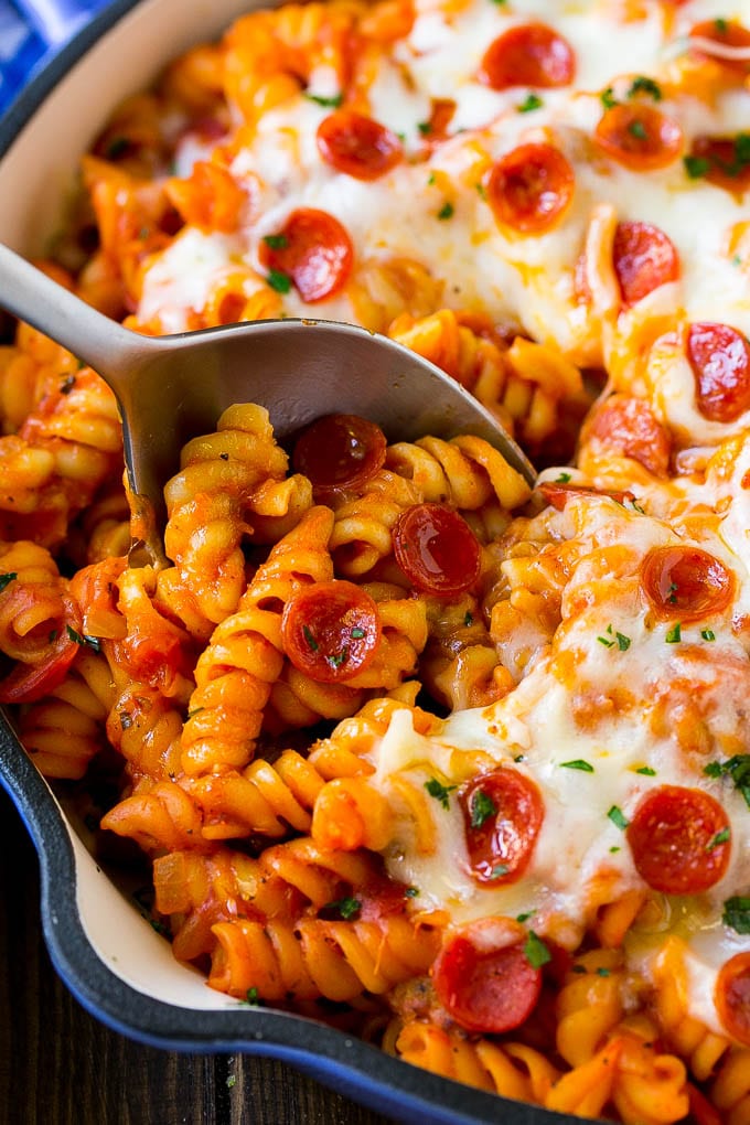 Pizza Pasta Recipe | Pepperoni Pasta | Sausage Pasta #italian #pepperoni #sausage #pizza #pasta #dinner #edsug #onepot A pan of pizza pasta with a serving spoon in it.