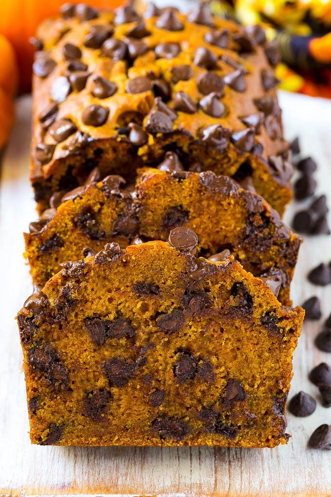 Pumpkin Chocolate Chip Bread Recipe | Pumpkin Bread | Chocolate Pumpkin Bread #pumpkin #bread #fall #chocolate #baking #dessert #edsug Sliced pumpkin chocolate chip bread on a serving board.
