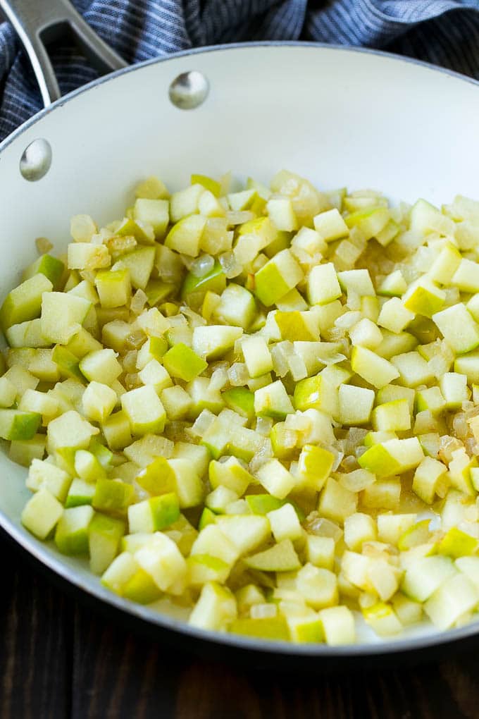Wild Rice Pilaf Recipe | Thanksgiving Side Dish | Rice Pilaf #rice #apple #cranberry #fall #glutenfree #thanksgiving #edsug Sauteed onions and apples in a skillet.