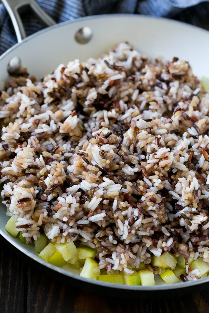 Wild Rice Pilaf Recipe | Thanksgiving Side Dish | Rice Pilaf #rice #apple #cranberry #fall #glutenfree #thanksgiving #edsug WIld rice, onions and apples in a skillet.