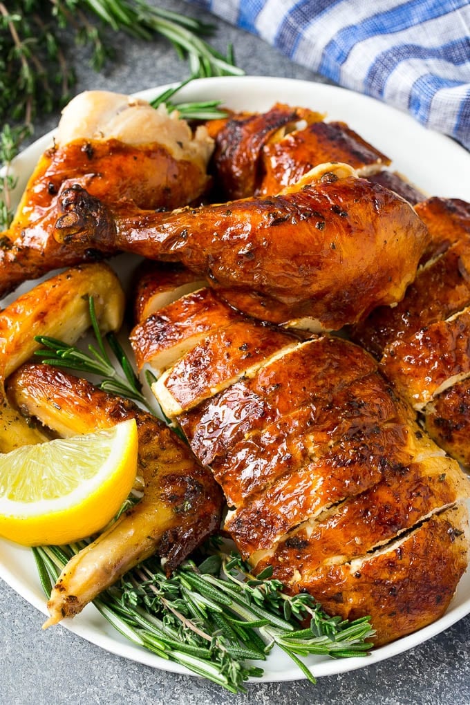 Roasted Chicken Recipe | Whole Roasted Chicken | Roast Chicken #chicken #dinner #lowcarb #keto #edsug Carved roasted chicken on a serving platter with fresh herbs.