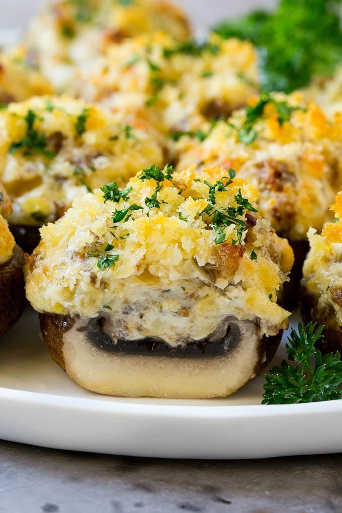 Sausage Stuffed Mushrooms Recipe | Stuffed Mushrooms | Mushroom Appetizer #mushrooms #sausage #appetizer #lowcarb #keto #edsug A cross section of a sausage stuffed mushroom on a serving platter.